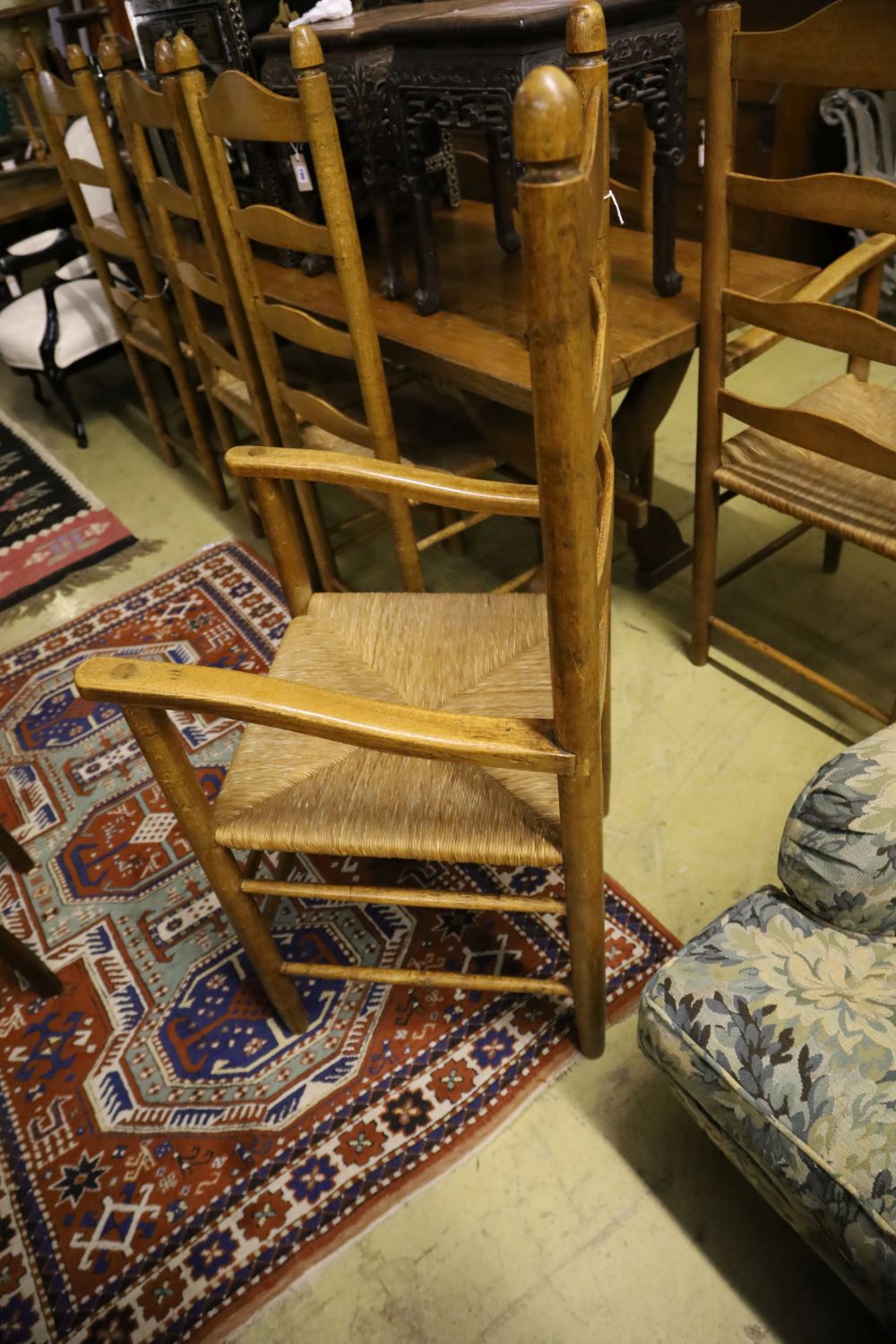 A set of eight ladder back rush seat dining chairs